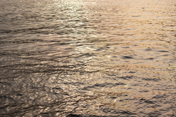 Evening sea at sunset. Water surface. Wavy sea background. Shallow depth of field.