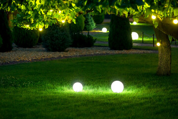 illumination garden light with electric ground lantern with ball diffuser lamp on meadow with...