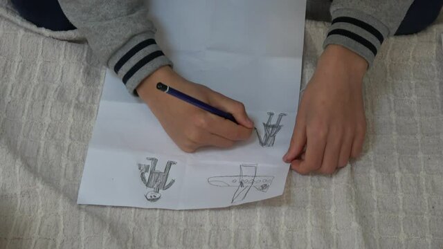 Fethiye, Turkey - 25th of January 2021: 4K English winter camp at the IBC - Child draws on paper a plane and people

