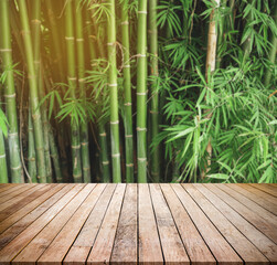 Old wood plank with abstract natural blurred bamboo forest background for product display