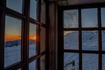 sunset seen through window with chipped glass,