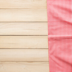 Classic pink plaid fabric or tablecloth on wood desk with copy space