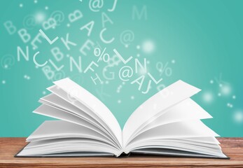 Open book with letters flying away. Education concept
