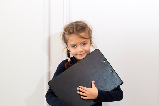 Happy Small Girl Hold File Paper Folder. Office Life. Schoolgirl Has Paperwork Homework. Back To School. Study Lesson. Knowledge And Education.