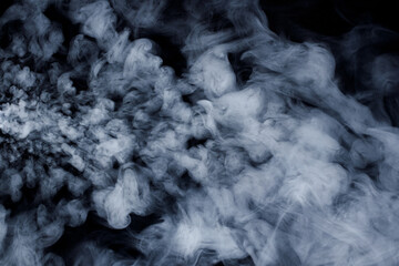 Abstract white smoke moves on black background. Beautiful swirling gray smoke.