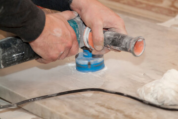 handyman cut round holes for electrical outlets in marble countertop for kitchen using electirc...