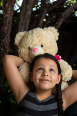 Teddy bear, Brazilian child playing with a lot of affection with his teddy bear, selective focus.