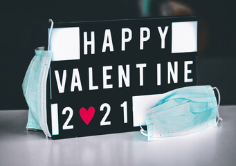 Happy valentines day 2021 text on board with 2 masks