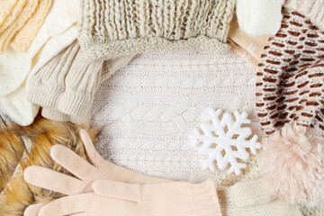 Fototapeta na wymiar winter flat lay with snowflake, mittens and hats