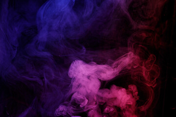 Abstract purple smoke moves on black background. Beautiful swirling smoke.
