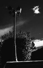
black and white photo of lamp post, in the field