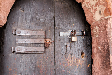 Old door with old padlock and lock