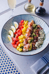 Cobb salad. Classic American restaurant or French bistro Cobb salad, made with chopped Bibb or Romain lettuce, heirloom tomatoes, bacon, blue cheese, avocado, hard boiled eggs tossed with olive oil.