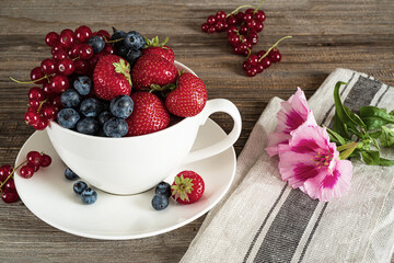 berries in a cup on wooden table