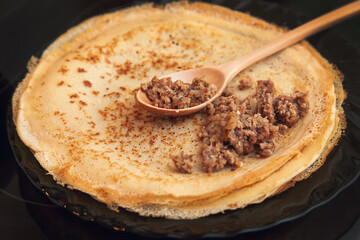 Cooking homemade Russian pancakes Bliny with meat on Shrovetide - Maslenitsa