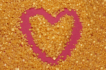 A heart shaped out of golden sugar crystals