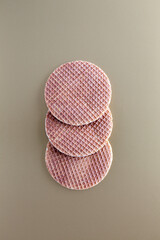 Three traditional Dutch stroopwafels (syrup or caramel waffles) on a golden background, copy space
