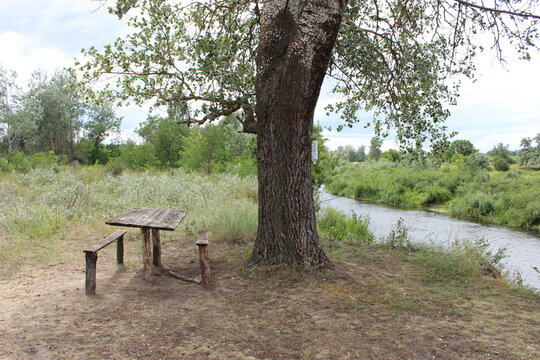 Table with benches on the river bank