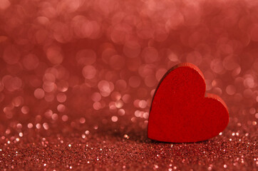 Red wooden heart on a shiny surface