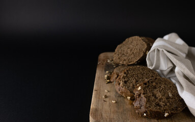 French baguette broken into pieces on a white kitchen towelwith a copy space. Top view
