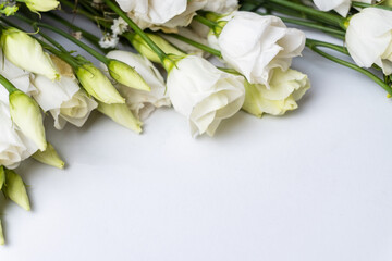 White eustoma flowers bunch. Place for text. Postcard. Selective focus.