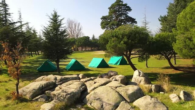 Green tent in 
camping area in nature