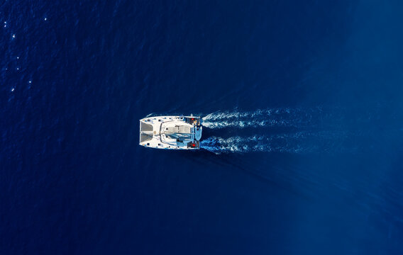 Croatia. Summer. Vacation. Aerial view of floating yacht on blue Adriatic sea at sunny day.  Sail boat on sea surface. Seascape from drone. Travel image