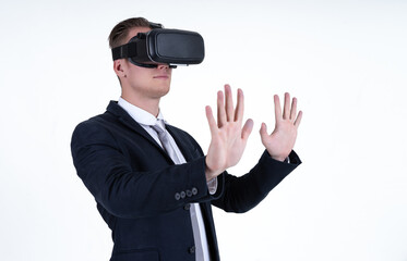 Portrait of young caucasian businessman wearing VR glasses and interacting with virtual reality isolated on white background. Technology concept