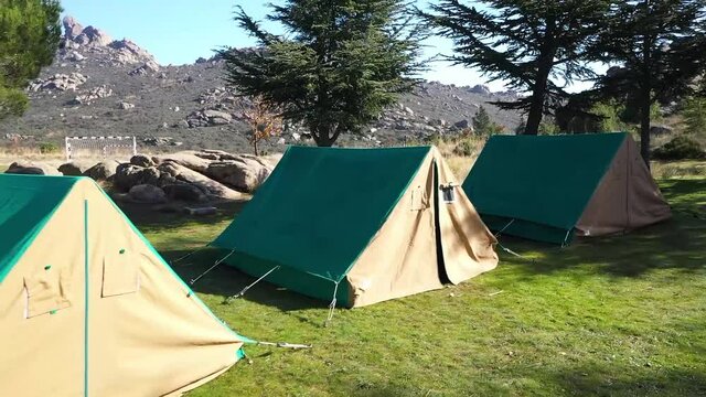 Green tent in 
camping area in nature