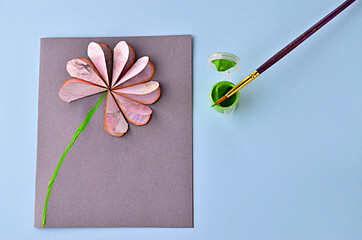 Step-by-step photo instruction how to make a greeting card with a flower. Step 12. Draw a green acrylic paint stalk flower. High quality photo