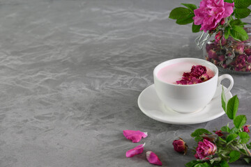 Rose moon milk in glasses on grey background. Front view. Close up.