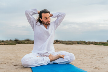 Naklejka na ściany i meble Concentrated Man Practicing Yoga Outdoors