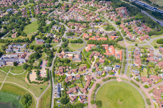 Aerial photo of the village of Milton Keynes in the UK showing a typical British housing estate on a sunny summers day taken with a drone from above