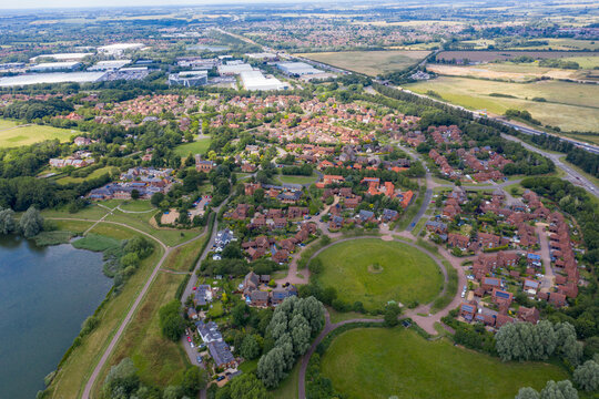 Aerial photo of the village of Milton Keynes in the UK showing a typical British housing estate on a sunny summers day taken with a drone from above