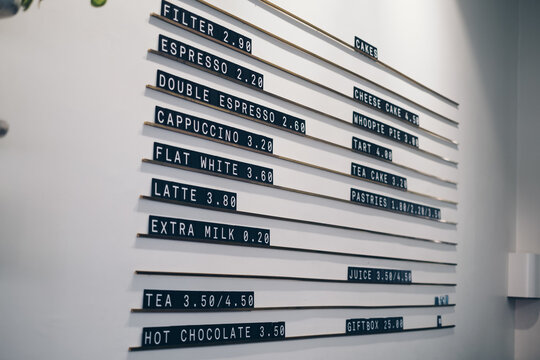 White wall of a cafe with a typesetting or hanging menu on it