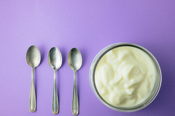 jar of yogurt with a small spoon