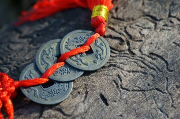 Chinese Feng Shui coin on a wooden background.