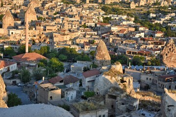 Fototapeta na wymiar View of the old city of Goreme Cappadocia Turkey with cave hotels. Dawn over the famous city which balloons are launched. Goreme national park