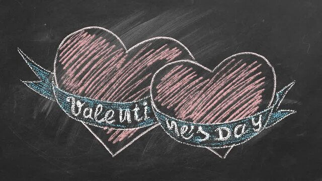 Lettering Valentines Day and two hearts are hand drawn with chalk on a blackboard. Love concept. I Love You. Seamless looping animation.