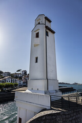Fototapeta na wymiar Old harbor lighthouse at the port entrance. Saint Jean de Luz, Pyrenees-Atlantiques department in southwestern France.
