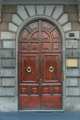 wooden door with a beautiful decorative finish in the historical part of Rome