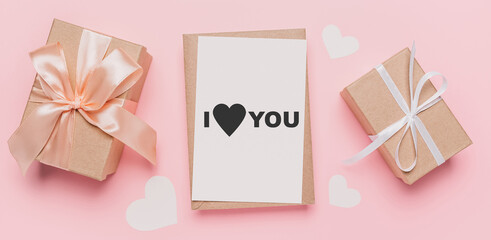 Fototapeta na wymiar Gifts with note letter on isolated pink background, love and valentine concept with text I love you