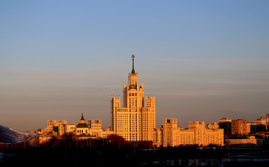 Fototapeta na wymiar Photo of a Soviet high rise illuminated by the sun