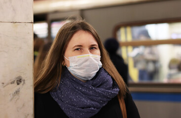 young european woman in protective disposable medical mask in metro. concept protection of dangerous 2019-nCoV influenza coronavirus, mutated and spreading in China