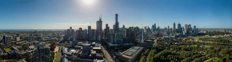 Aerial wide panorama of Melbourne. Modern urban high-rise towers and architecture on CBD waterfront.