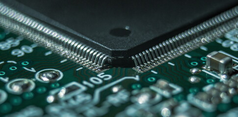 macro photography of integrated circuit in QFP package assembled on printed circuit board