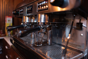Fototapeta na wymiar Coffee machine while preparing delicious coffee
