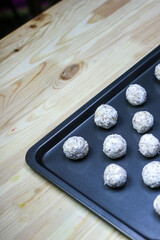 raffaello and bounty style pastry with coconut on a baking sheet