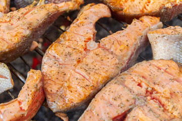 Large fish steaks fresh trout fried in spices on the grill