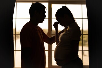 A husband comforting his stressed worried wife at home. Pregnancy and relationship problems. Depression.